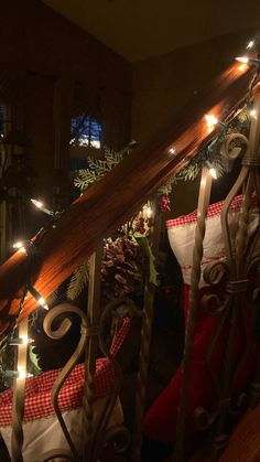 christmas stockings on the bannister railing with lights