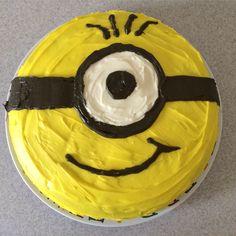 a yellow cake with black icing and a minion face