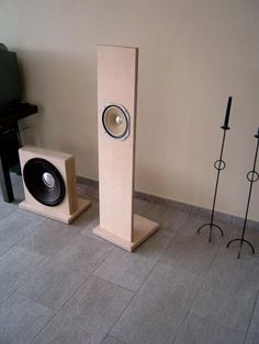 two speakers sitting next to each other on the floor