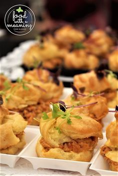 several small sandwiches on trays with garnishes