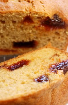 a loaf of bread with raisins and jam on it sitting on a cooling rack