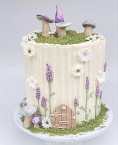 a cake with white frosting and purple decorations