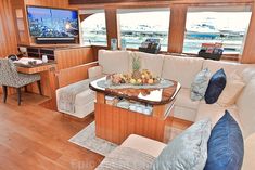 a living room filled with furniture and a flat screen tv on top of a wooden wall