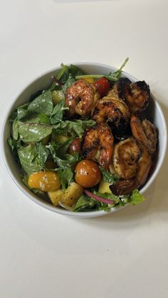 a white bowl filled with salad and shrimp