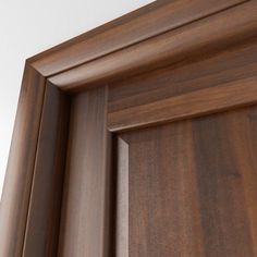 a close up view of the wood grains on an interior door with white walls