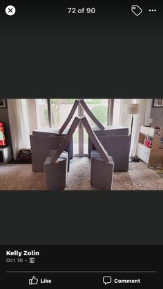 an image of a living room with furniture and boxes on the floor in front of a window