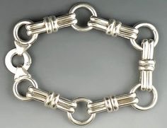 Presented is a classy sterling silver bracelet made in Italy.     It is marked "925" for sterling and also stamped "Italy".     It bears the hallmarks that signify it was imported from England at one time.     To me, this bracelet has the appearance of the signature style of Gucci.     The clasp is very sturdy.     It is in great condition.     Ready to grace your wrist!     Length: 8 inches from end to end.     Weight: 40.1 grams.     Described by: ARB Jewelry Bracelets Silver, Sterling Silver Charm Bracelet, Silver Charm Bracelet, Star Bracelet, Bracelet Clasps, Sterling Silver Bracelet, Sterling Silver Chain, Sterling Silver Charm, Chain Link Bracelet