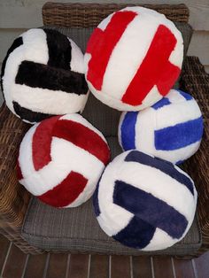 four different colored balls sitting on top of a wicker basket next to each other