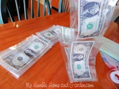 five bundles of one hundred dollar bills sitting on top of a wooden dining room table