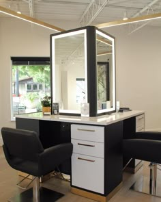 a hair salon with two chairs and a large mirror