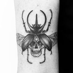 a black and white photo of a beetle on the arm