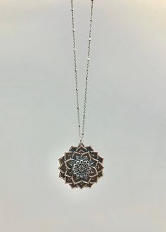 "This gorgeous silver mandala pendant is a visual stunner! Measuring 35 mm in length, this pendant is made of sterling silver and is strung on a beautiful sterling silver chain. The chain is quite beautiful thanks to tiny silver beads that dot along the chain and add extra sparkle as the light catches the flat edge. The model is wearing a 18\" length. This multi petaled flower is grounded in it's symmetry and beauty. It has a lovely weight and is an impressive piece in your collection." Silver Round Pendant Necklace For Meditation, Spiritual Silver Medallion Pendant Necklace, Silver Spiritual Medallion Necklace With Large Pendant, Spiritual Style Silver Medallion Necklace With Large Pendant, Spiritual Silver Medallion Necklace With Large Pendant, Silver Engraved Necklace For Meditation, Sterling Silver Engraved Necklaces For Meditation, Silver Medallion Necklace For Meditation, Sterling Silver Beads Jewelry For Meditation