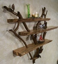 a shelf made out of branches with candles on it and other items sitting on the shelves