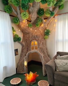 a living room decorated with paper trees and fairy lights on the ceiling, along with other decorations