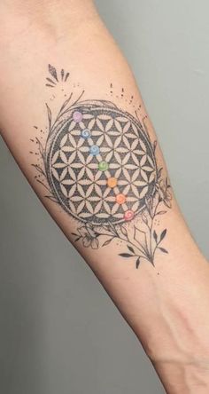 a flower of life tattoo on the arm