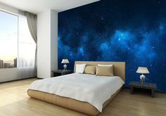 a large bed sitting under a blue sky filled with stars