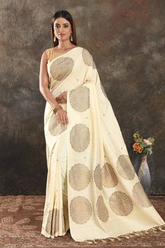 Buy beautiful cream Muga Banarasi saree online in USA with antique zari motifs. Be vision of elegance on special occasions in exquisite designer sarees, handwoven sarees, georgette sarees, embroidered sarees, Banarasi saree, pure silk saris from Pure Elegance Indian saree store in USA.-full view Festive Cream Pre-draped Saree With Cutdana, Traditional Pre-draped Cream Saree, Festive Semi-stitched Cream Pre-draped Saree, Designer Cream Pre-draped Saree With Zari Work, Traditional Drape Art Silk Blouse Piece In Cream, Festive Cream Blouse Piece In Traditional Drape, Festive Cream Blouse Piece With Traditional Drape, Festive Designer Cream Pre-draped Saree, Cream Blouse Piece With Traditional Drape For Festive Occasions