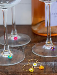 three wine glasses sitting on top of a wooden table