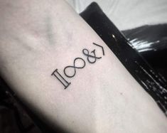 a person with a tattoo on their arm that says boo and is written in cursive font