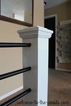 a close up of a white rail in a room with beige walls and carpeted flooring