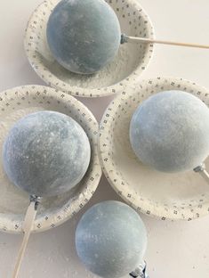 three blue and white bowls with toothpicks in them