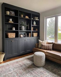 a living room filled with furniture and a large window