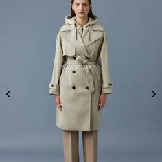 Trisha Is A 2-In-1 Trench Coat Tailored From A 100% Recycled 2-Layer Shell. It Boasts A Removable Hooded Bib Made From Sustainable Lustrous Light Down. A Classic Double-Breasted Silhouette, The Wide Notch Lapel, Asymmetrical Rain Shedder, And Raglan Epaulette Shoulders Add A Modern Feel. Detailed With A Sash Belt And Button-Tab Cuffs. A Refined Staple With Modern Versatility. Three-Quarter Trench Coat 100% Recycled 2-Layer Shell Removable Sustainable Lustrous Light Down Bib With Zip Closure And Luxury Hooded Outerwear For Spring, Mackage Jacket, Light Down, Black Down, Puffer Jacket Women, Wrap Coat, Sash Belt, French Seam, Down Coat