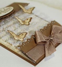 a close up of a small card with some bows on the front and back of it