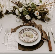 the table is set with plates and silverware