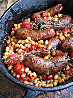 sausages, tomatoes and corn in a cast iron skillet