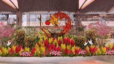 a garden with flowers and plants in the foreground is an image of a dragon