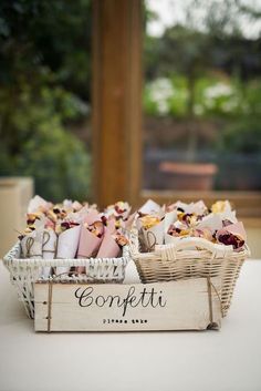 two baskets filled with food sitting on top of a table next to each other and the words confetti written in cursive