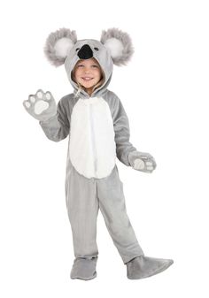 a little boy in a koala costume standing with his hands out and smiling at the camera