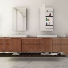 a bathroom with two sinks and a mirror on the wall above it is white tile flooring