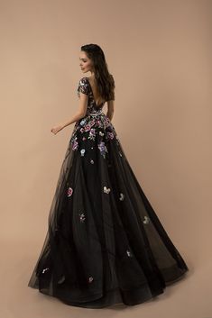 Embrace the allure of our "Gothic Black Floral Tulle Wedding Dress - Appliqué Embroidered Evening Gown Plus Size," where dark elegance meets blooming romance. This dress is a celebration of gothic beauty, featuring lush floral appliqués that cascade over layers of sumptuous black tulle. Each embroidered bloom is a testament to craftsmanship, adding a vibrant burst of color that stands out against the night-inspired fabric. The gown's silhouette, designed with an A-line cut, promises to flatter a Evening Gown Plus Size, Prom Gown Elegant, Nontraditional Wedding Dress, Purple Wedding Dress, Dark Fabric, Gown Plus Size, Applique Wedding Dress, Evening Gowns Elegant, Queen Dress