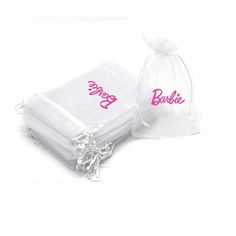 two bags with the word barbie on them are sitting next to each other in white