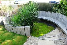 a circular bench sitting in the middle of a garden