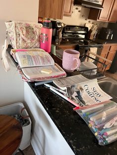 the kitchen counter is cluttered with papers and magazines