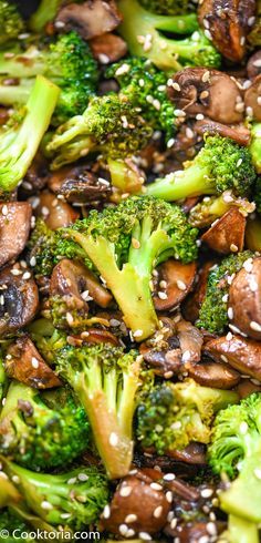 broccoli, mushrooms and sesame seeds are mixed together in a stir - fry