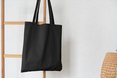 Black colour cotton tote bag. (Plain and Blanks Bags) The bag is 100% cotton (130gsm). Can be carried by hand or over the shoulder.  Handle length 60cm.  Dimensions: 38 x 42cm Note: Bag colours might vary slightly from the mockup images shown here.  We have other colours in these bags Teacher Library, Black Blank, Library Bag, Bag Hanger, Bag Designs, Bag Mockup, Craft Printing, Fabric Bags, Cotton Tote Bag