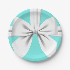 a paper plate with a large bow on the top and bottom, in turquoise and white