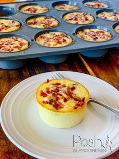 a muffin on a plate with a fork in front of the muffins