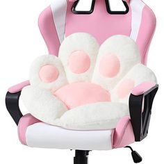 a pink and white chair with a stuffed animal on it's armrests