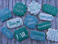 decorated cookies with different sayings on them sitting on top of a wooden table next to each other