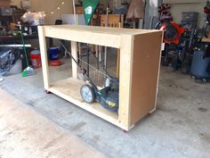 a box with some tools inside of it on the floor next to other items in a garage