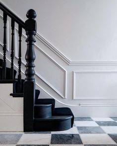 a black and white checkered floor with stairs