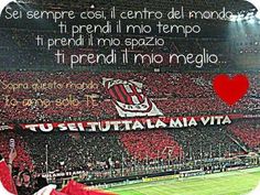 a stadium filled with lots of people sitting on top of a soccer field next to a red heart