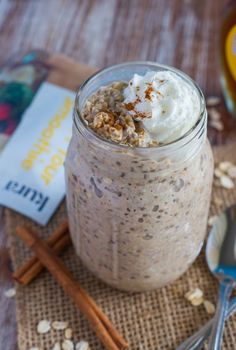 a jar filled with oatmeal sitting on top of a table next to spoons