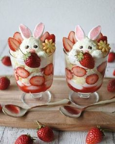 two glasses filled with strawberries and topped with bunny ears