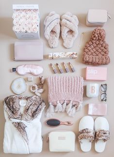 the contents of a woman's purse and shoes laid out on top of a table